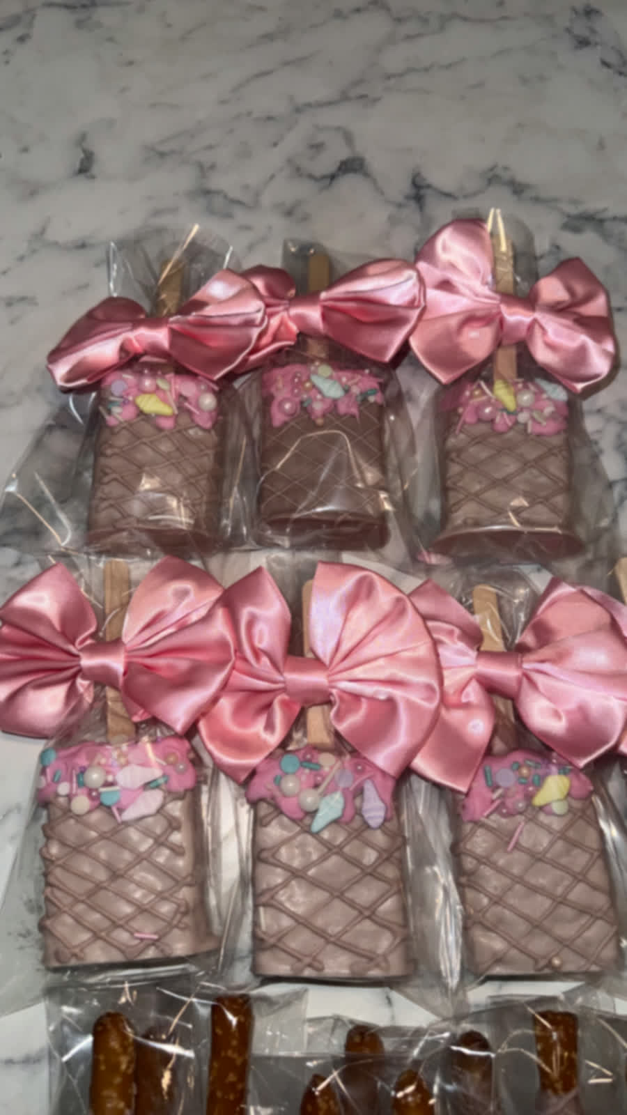 Chocolate covered treats with pink satin bows
